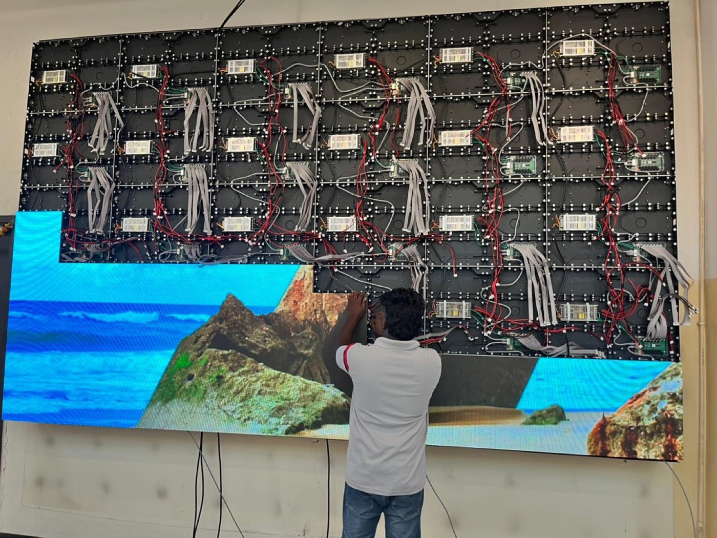 CBM IMPEX technician fitting LED modules onto a video wall frame