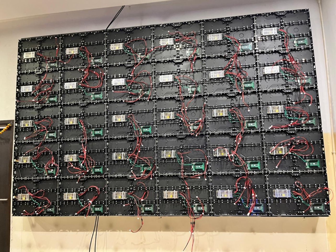 Rear structure of an LED video wall showing power supplies, receiving cards and cabling